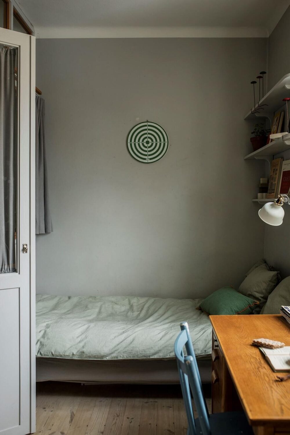 A Small Swedish Apartment Decorated in Midcentury Style 12 small-light-gray-bedroom-shelves-desk-nordroom