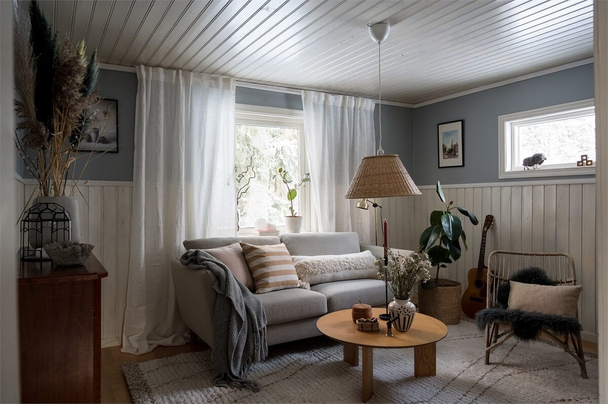 A Charming Countryside Villa in Sweden 9 small-living-room-wood-paneling-light-blue-walls-nordroom