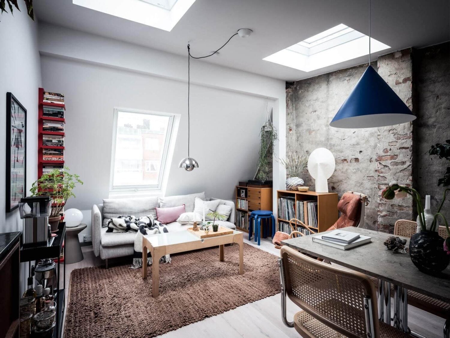 A Small Scandinavian Loft with Skylights and Brick Wall 2 small-loft-sitting-area-skylights-exposed-brick-wall-nordroom