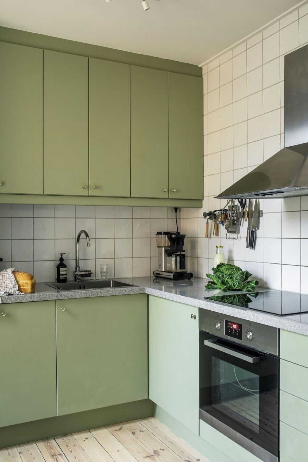 A Serene Light Colored Apartment in Stockholm 6 small-mint-green-kitchen-wooden-floorboards-nordroom