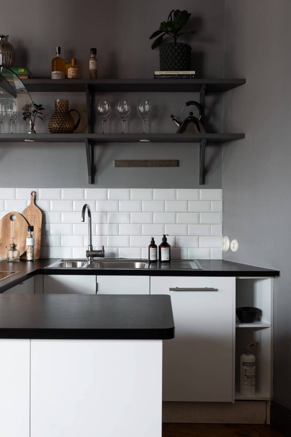 A Stylish Gray Apartment in Stockholm 11 small-u-shaped-kitchen-white-cabinets-open-shelves-nordroom