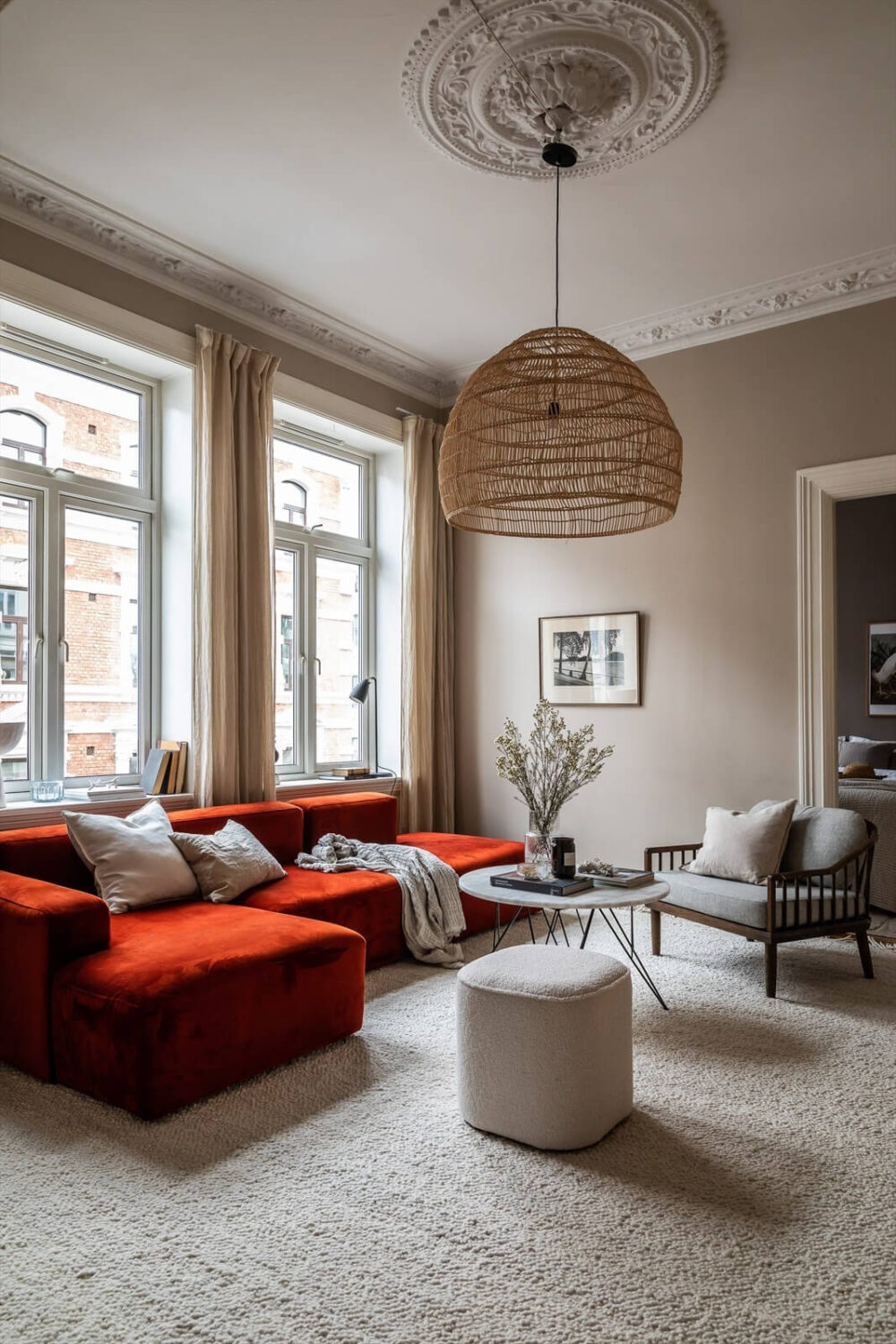 An Oslo Apartment Painted in Warm Color Tones 1 soft-colored-living-room-ceiling-ornaments-red-sofa-nordroom