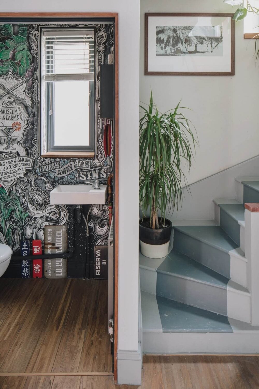 A London Home with Moody Rooms and a Pink Kitchen 10 staircase-blue-gray-powder-room-wallpaper-nordroom