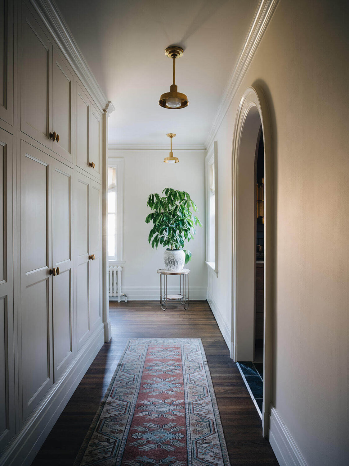 A Classic 1930s Home in Grand Rapids Designed by Jean Stoffer 31 walk-in-closet-dark-wooden-floor-runner-nordroom