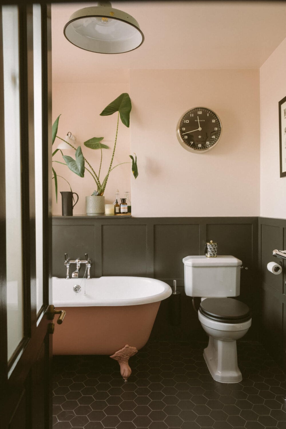 A Victorian House in London Decorated in Warm Color Tones 31 bathroom-black-hexagon-floor-tiles-pink-clawfoot-bath-nordroom