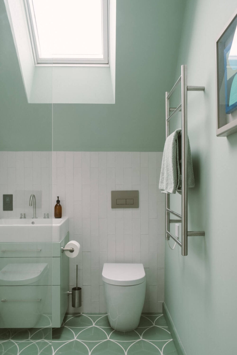 A Modern Split-Level Home with Colorful Rooms 21 bathroom-mint-green-walls-tiles-slanted-ceiling-skylight-nordroom