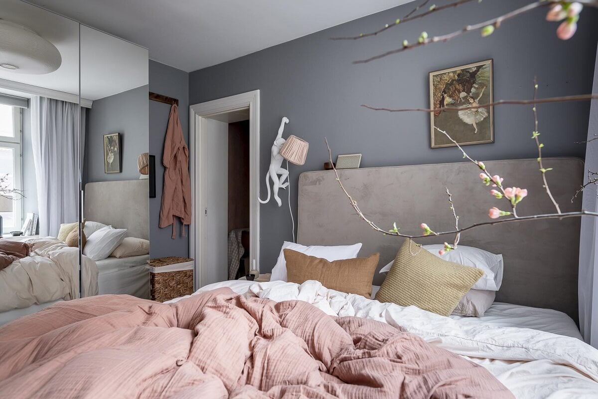 Layered Textiles and Dusty Colors in a Nordic Apartment 15 bedroom-mirror-wardrobe-gray-walls-nordroom