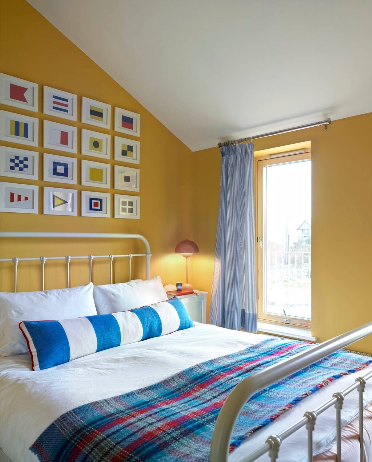 A Colorful House By The Sea Designed by Space A 11 bedroom-yellow-walls-slanted-ceiling-nordroom