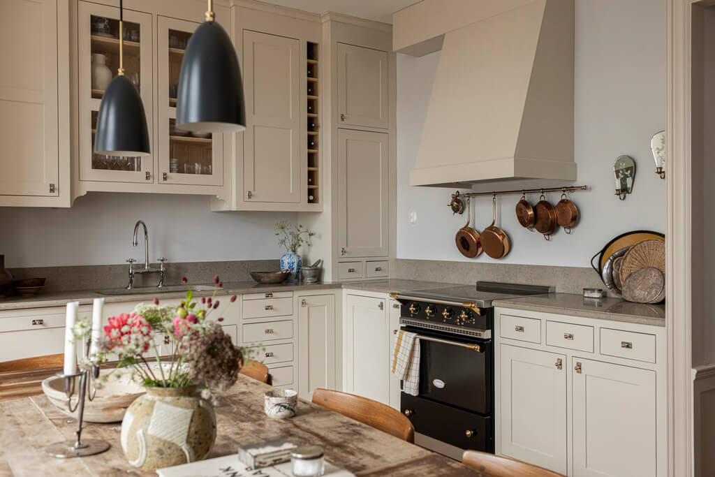 A Scandinavian Apartment with Antique Furniture 6 beige-kitchen-cabinets-wooden-table-scandi-apartment-nordroom