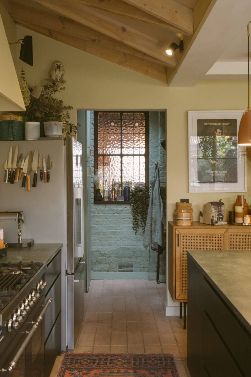 A Victorian House in London Decorated in Warm Color Tones 10 black-kitchen-stone-floor-wooden-beams-slanted-ceiling-nordroom