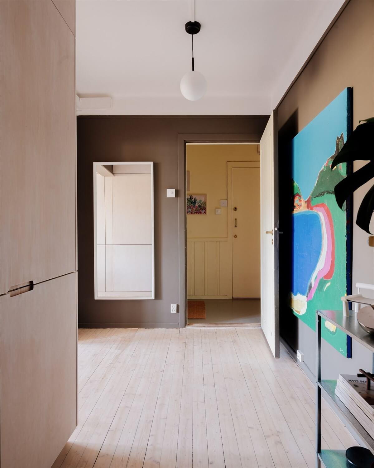 A Modern Oslo Apartment with Custom Furniture and Storage 20 dark-entry-wooden-floor-large-artwork-nordroom
