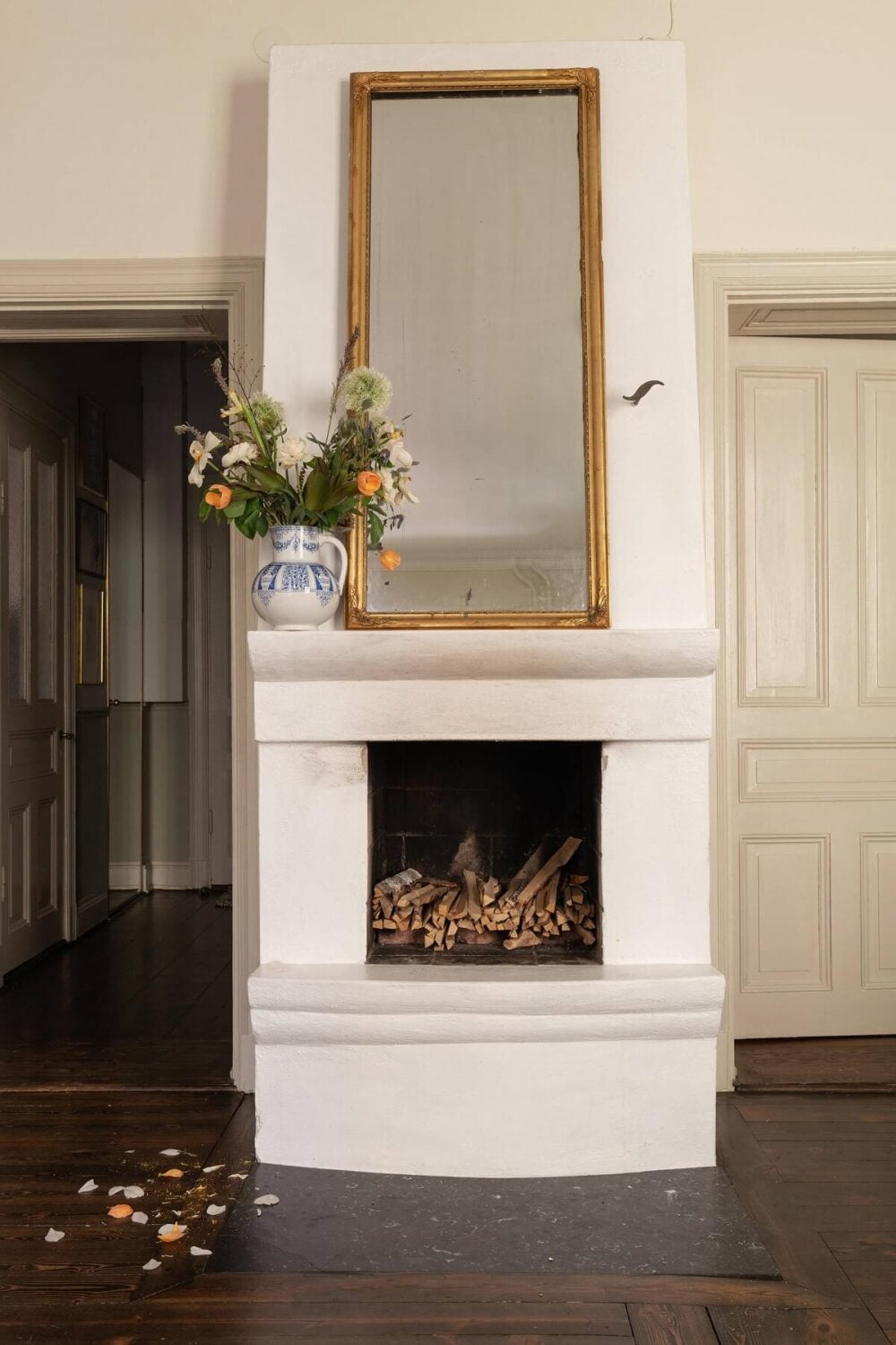 A Classic Maisonette Home in Stockholm 7 dark-wooden-floor-fireplace-antique-mirror-nordroom