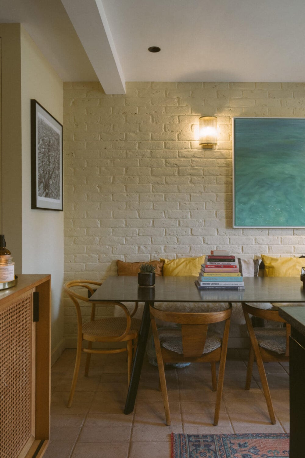 A Victorian House in London Decorated in Warm Color Tones 11 dining-table-bench-painted-brick-wall-nordroom