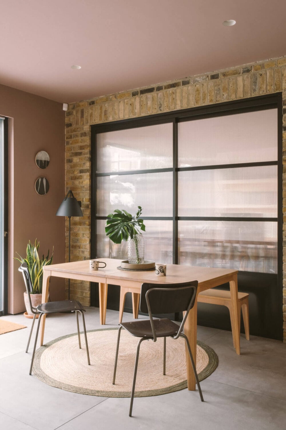 A Modern Split-Level Home with Colorful Rooms 14 exposed-brick-wall-industrial-window-dining-space-nordroom