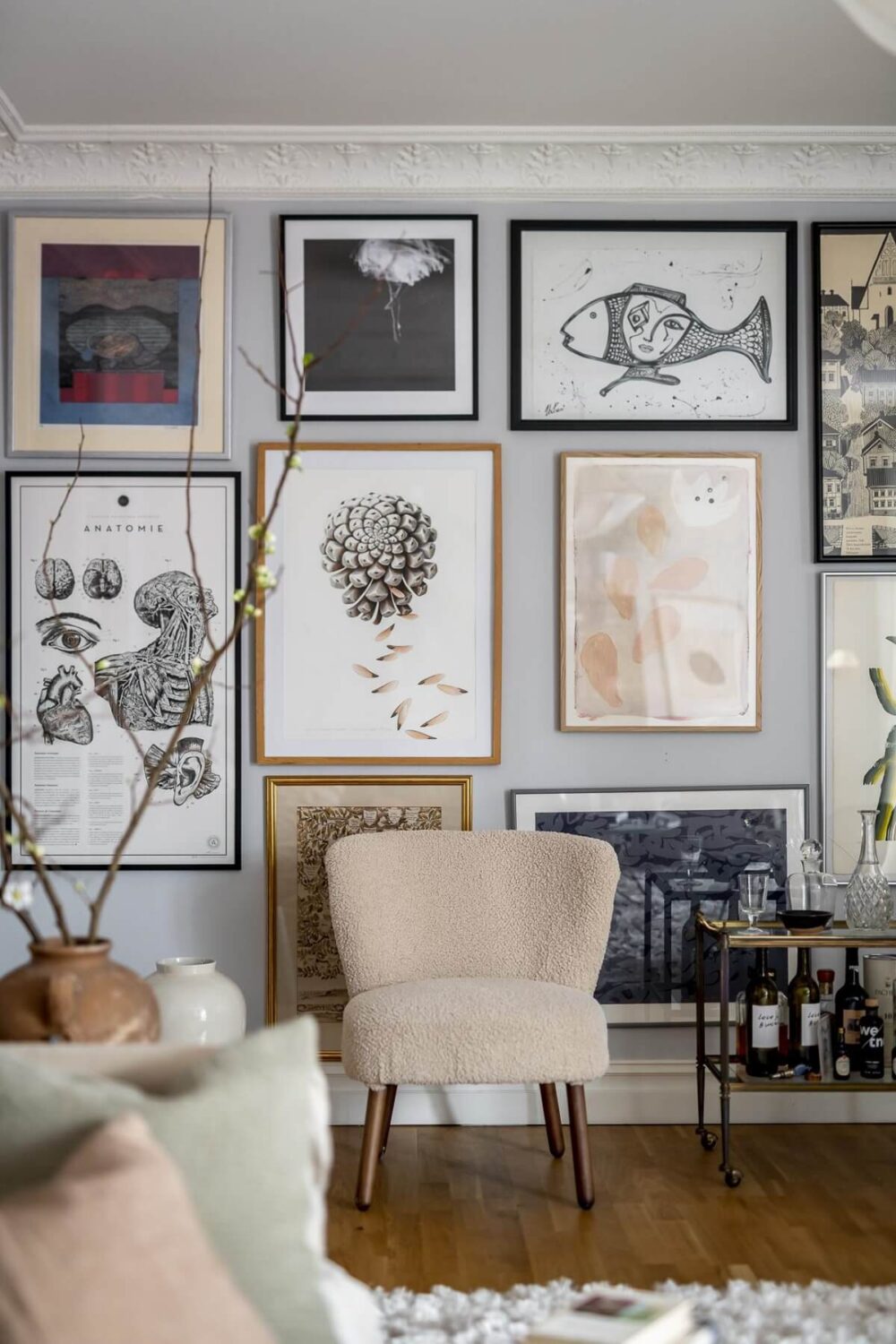 Layered Textiles and Dusty Colors in a Nordic Apartment 8 gallery-wall-accent-chair-nordic-design-nordroom