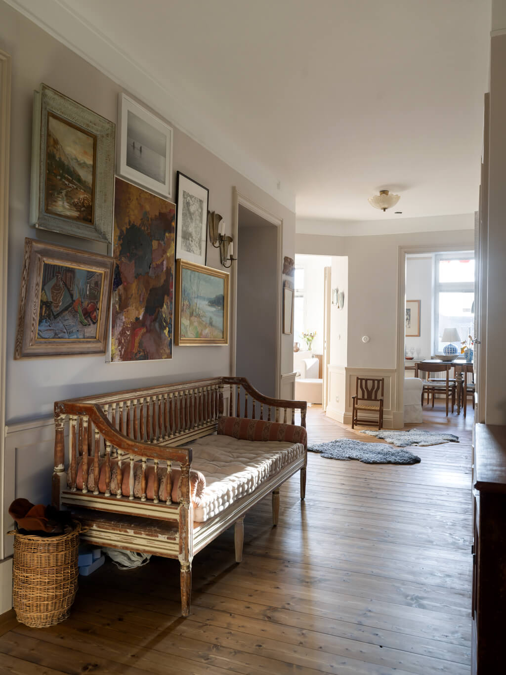 A Scandinavian Apartment with Antique Furniture 15 hallway-wooden-floor-antique-bench-gallery-wall-nordroom