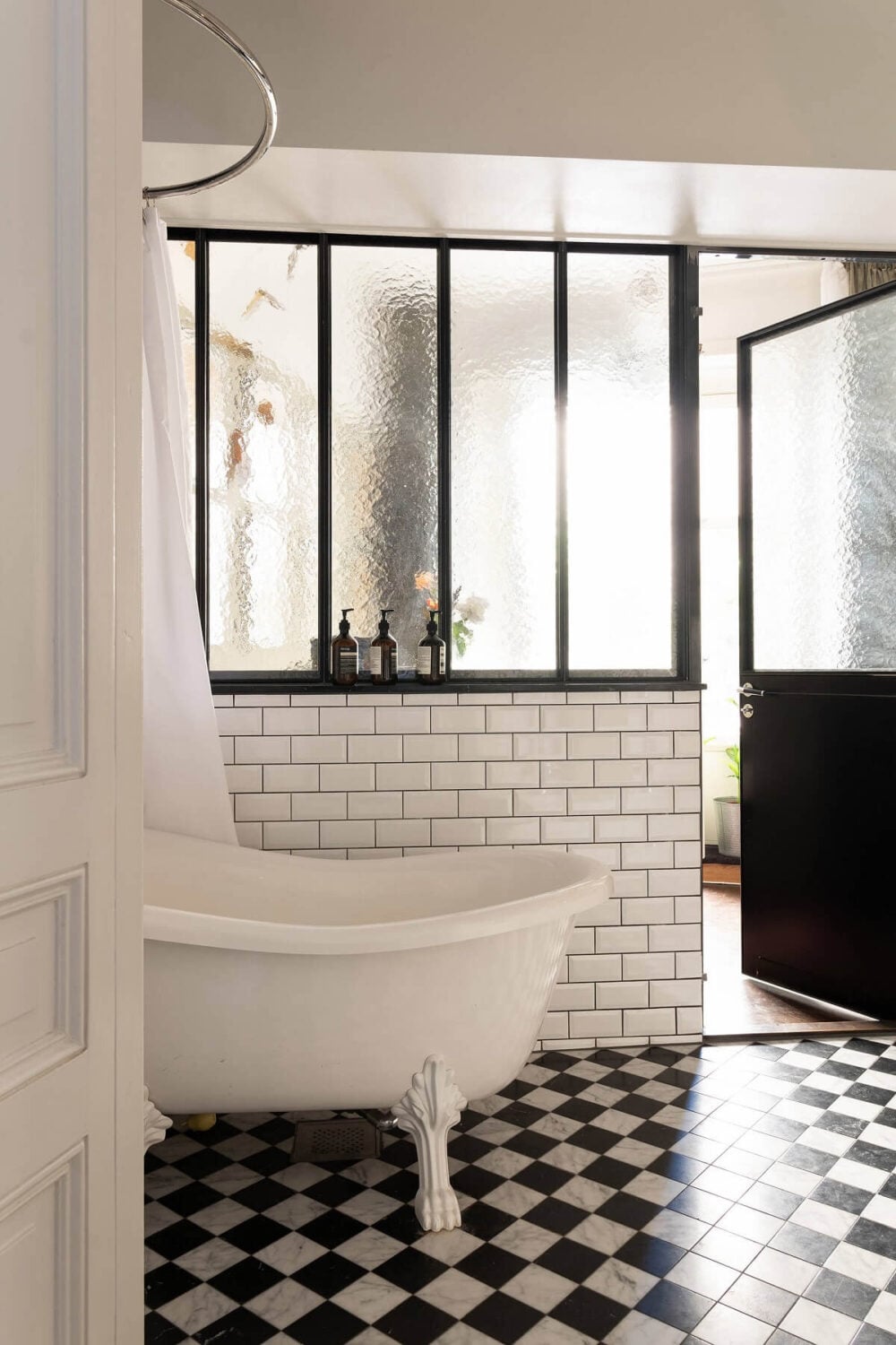 A Classic Maisonette Home in Stockholm 13 industrial-glass-windows-bathroom-freestanding-bath-black-white-checkerboard-floor-nordroom