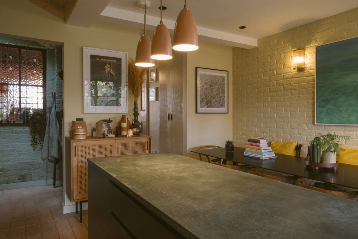 A Victorian House in London Decorated in Warm Color Tones 9 kitchen-concrete-worktop-soft-pink-pendants-nordroom