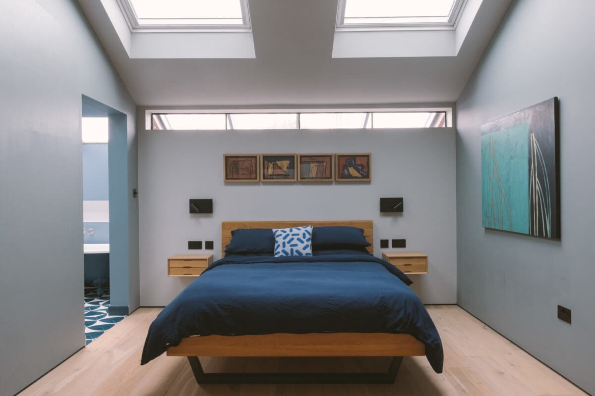 A Modern Split-Level Home with Colorful Rooms 22 light-blue-bedroom-skylights-nordroom
