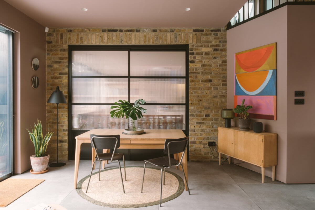 A Modern Split-Level Home with Colorful Rooms 13 living-room-exposed-brick-wall-pink-walls-nordroom