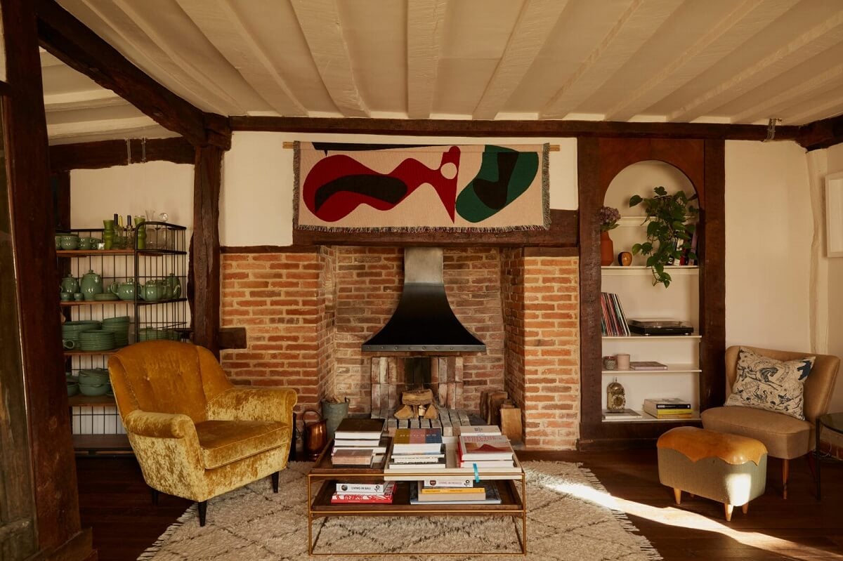 A Pink English Home That's Brimming with History 3 living-room-firpelace-ohre-yellow-sofa-wooden-beams-nordroom