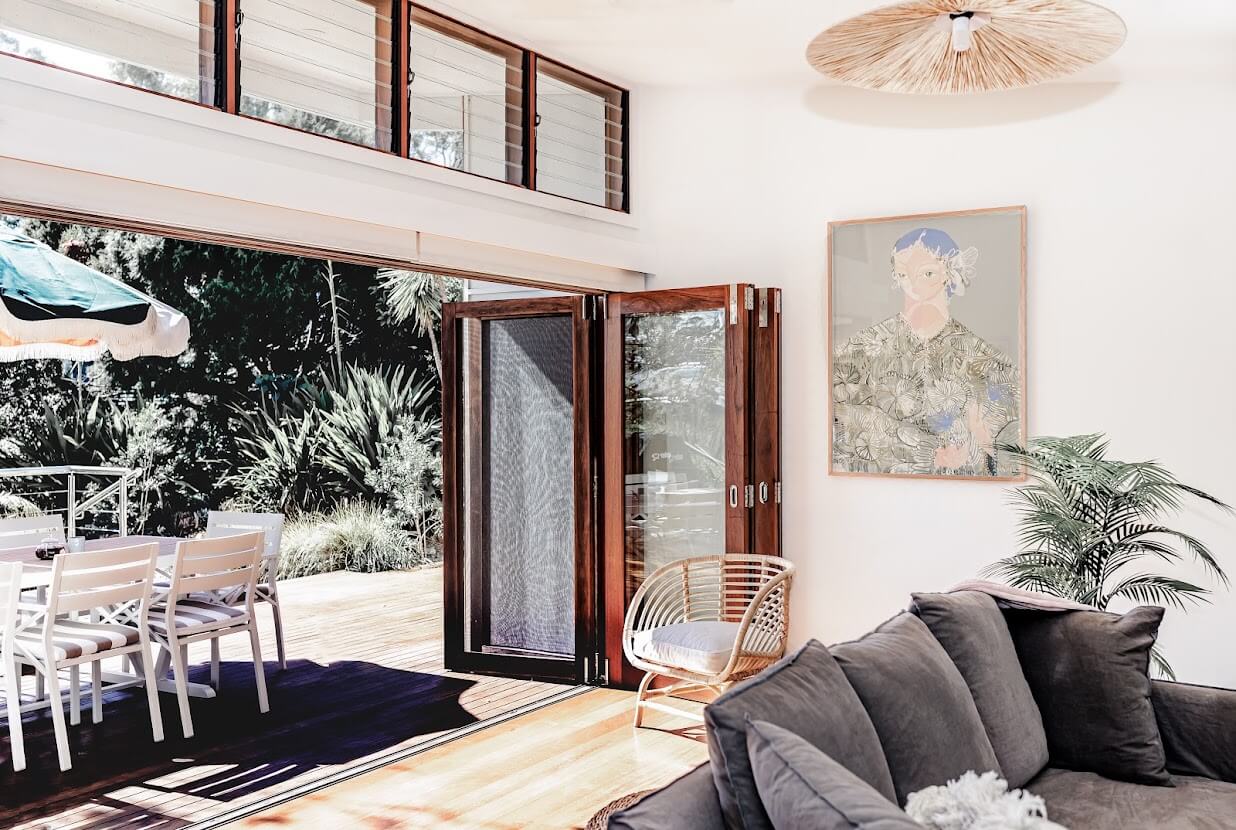 Oyster Catcher Huskisson: A Sustainable Beach House in Australia 3 living-room-gray-sofa-folding-doors-indoor-outdoor-living-nordroom