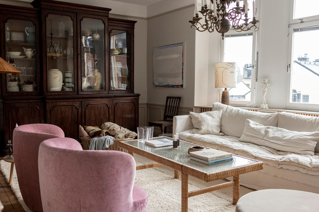 A Scandinavian Apartment with Antique Furniture 3 living-room-large-antique-cabinet-pink-armchairs-nordroom