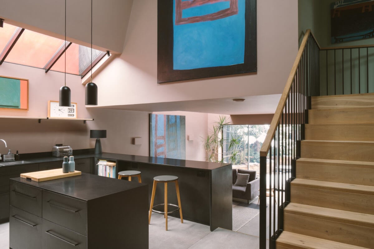 A Modern Split-Level Home with Colorful Rooms 2 modern-black-kitchen-island-pink-walls-nordroom