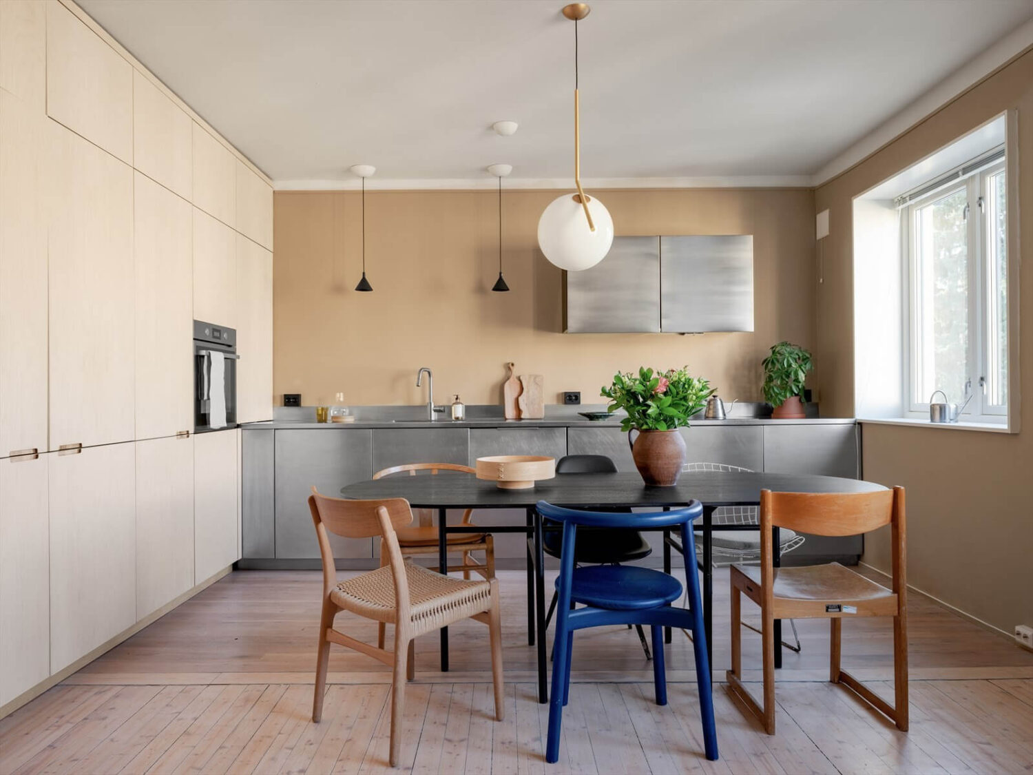 A Modern Oslo Apartment with Custom Furniture and Storage 6 modern-kitchen-stainless-steel-cabinets-dining-space-nordroom