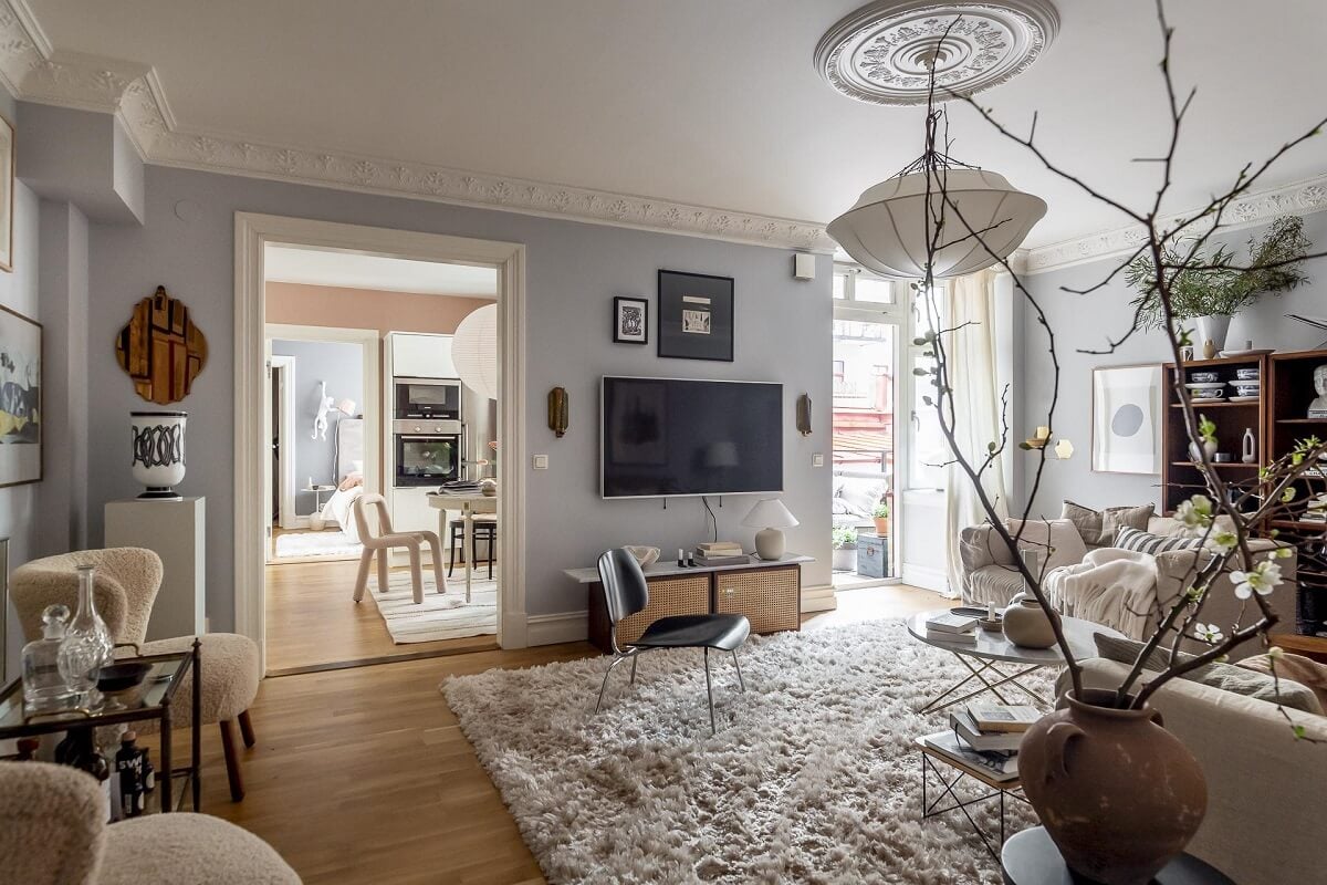 Layered Textiles and Dusty Colors in a Nordic Apartment 6 nordic-living-room-light-blue-walls-large-rug-nordroom