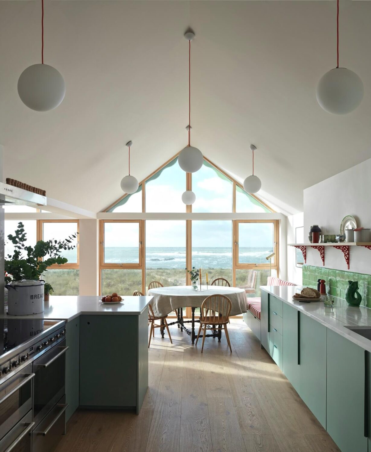 A Colorful House By The Sea Designed by Space A 4 open-plan-kitchen-dining-room-pitched-ceiling-sea-view-nordroom