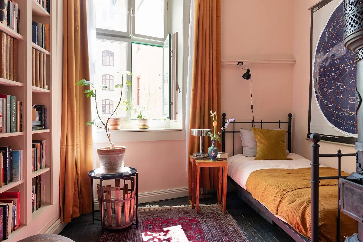 A Classic Maisonette Home in Stockholm 16 pink-bedroom-bookcase-ochre-yellow-accent-color-nordroom
