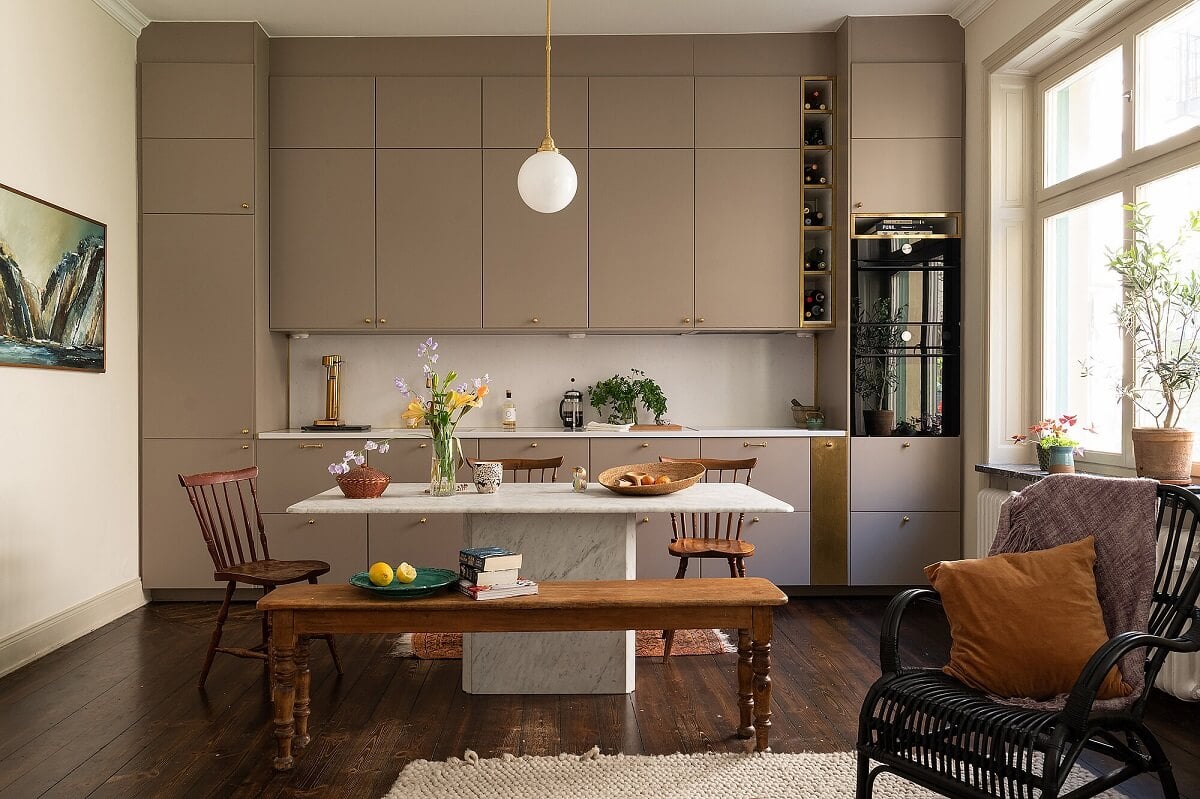 A Classic Maisonette Home in Stockholm 3 gray-kitchen-brass-fixtures-dining-table-nordroom