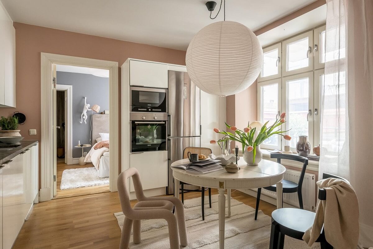 Layered Textiles and Dusty Colors in a Nordic Apartment 11 round-dining-table-kitchen-dusty-pink-walls-nordroom