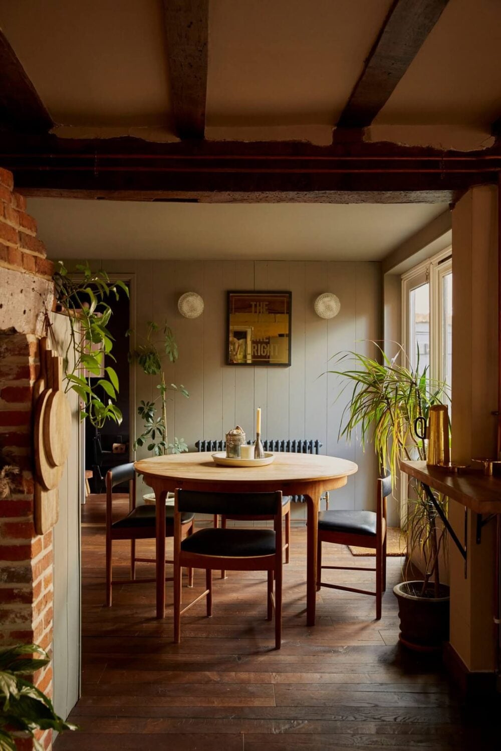 A Pink English Home That's Brimming with History 9 round-dining-table-wooden-floor-exposed-beams-nordroom