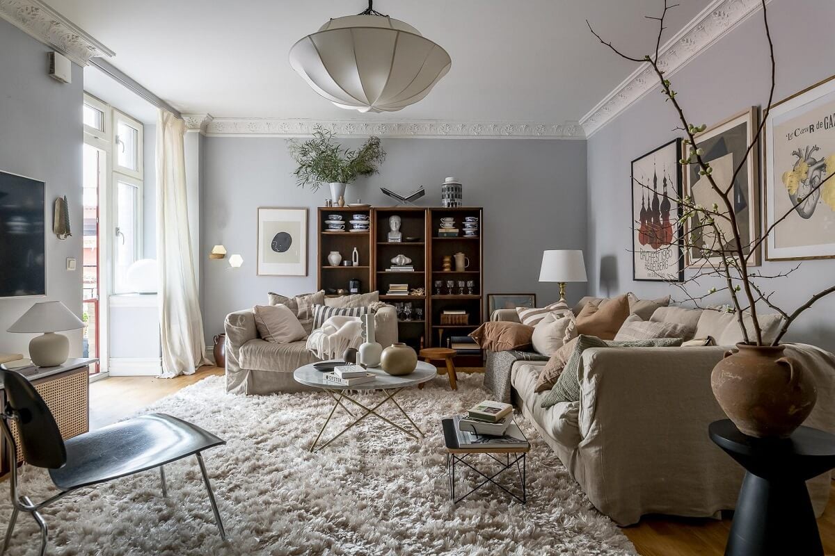 Layered Textiles and Dusty Colors in a Nordic Apartment 3 scandinavian-living-room-light-blue-walls-large-rug-nordroom