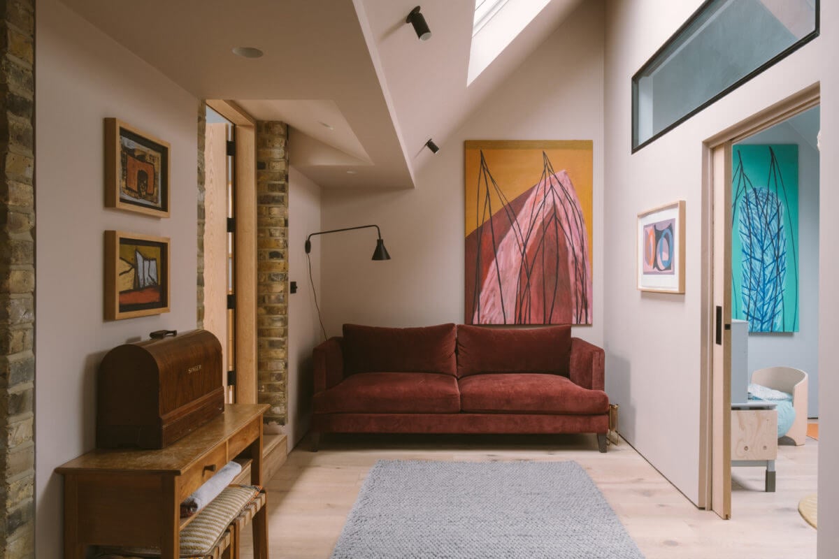 A Modern Split-Level Home with Colorful Rooms 16 small-sitting-room-snug-earthy-red-sofa-skylight-art-nordroom