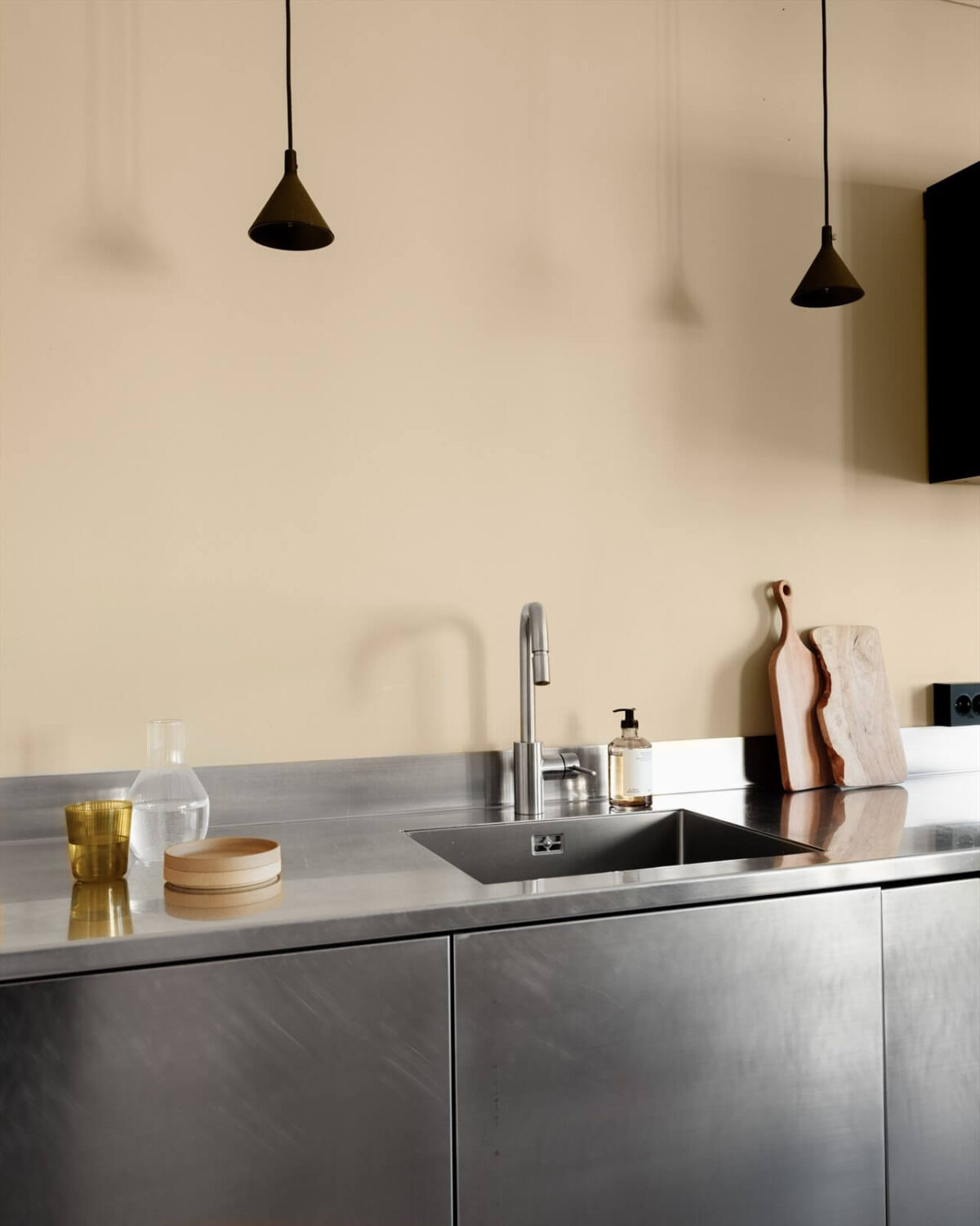 A Modern Oslo Apartment with Custom Furniture and Storage 9 stainless-steel-kitchen-small-pendant-lights-nordroom