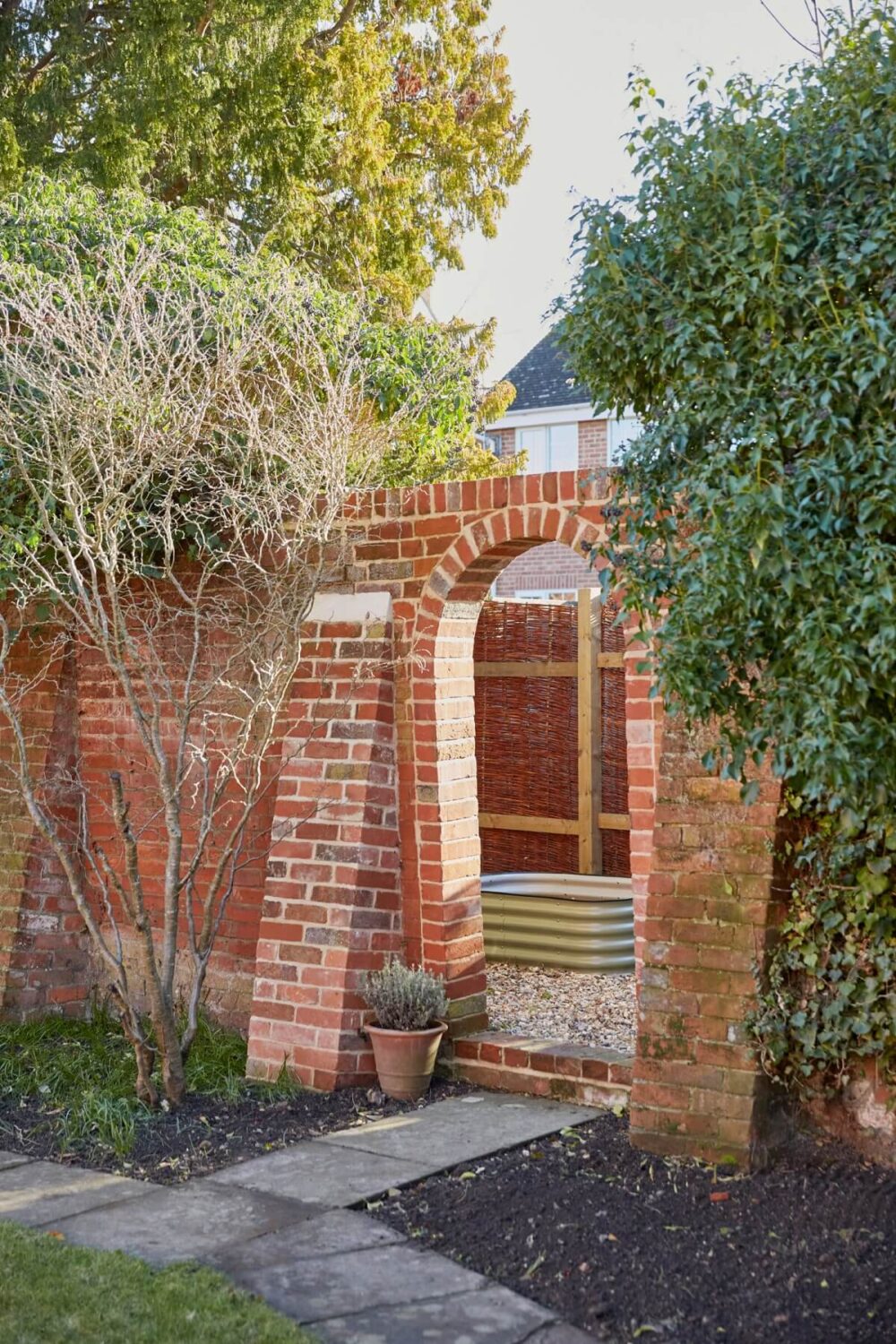 A Pink English Home That's Brimming with History 25 stone-garden-wall-arched-doorway-nordroom