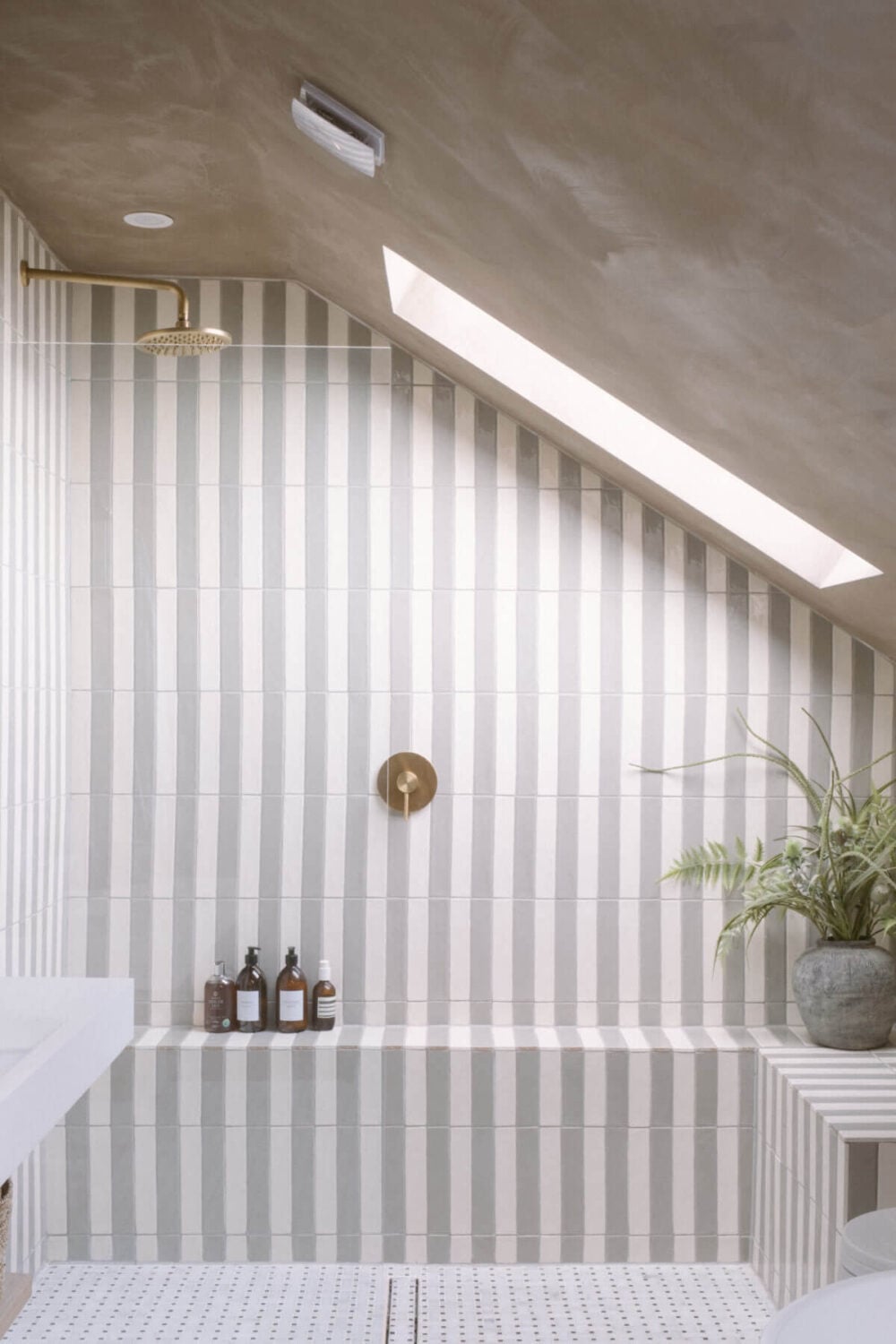 A Serene Renovated Victorian House in London 31 striped-tiles-walk-in-shower-bathroom-slanted-ceiling-nordroom