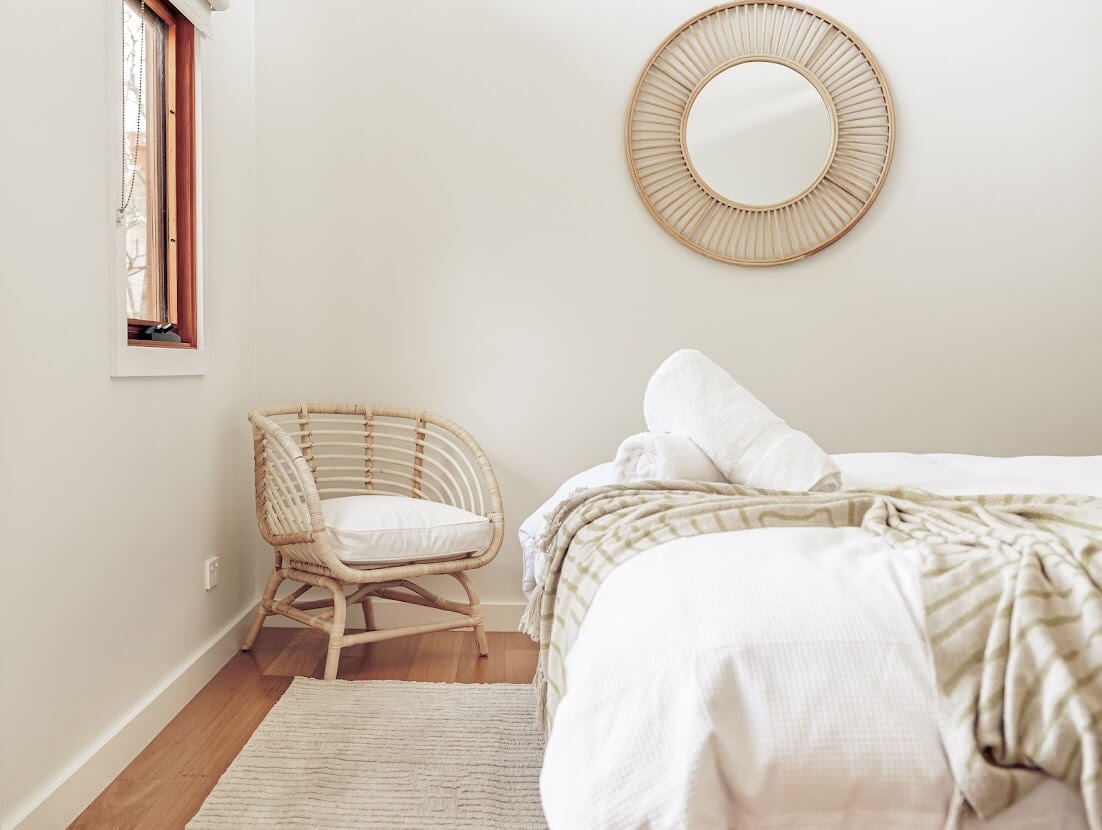 Oyster Catcher Huskisson: A Sustainable Beach House in Australia 23 white-bedroom-rattan-round-mirror-nordroom