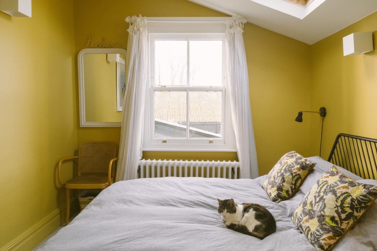 A Victorian House in London Decorated in Warm Color Tones 35 yellow-bedroom-slanted-ceiling-skylight-nordroom