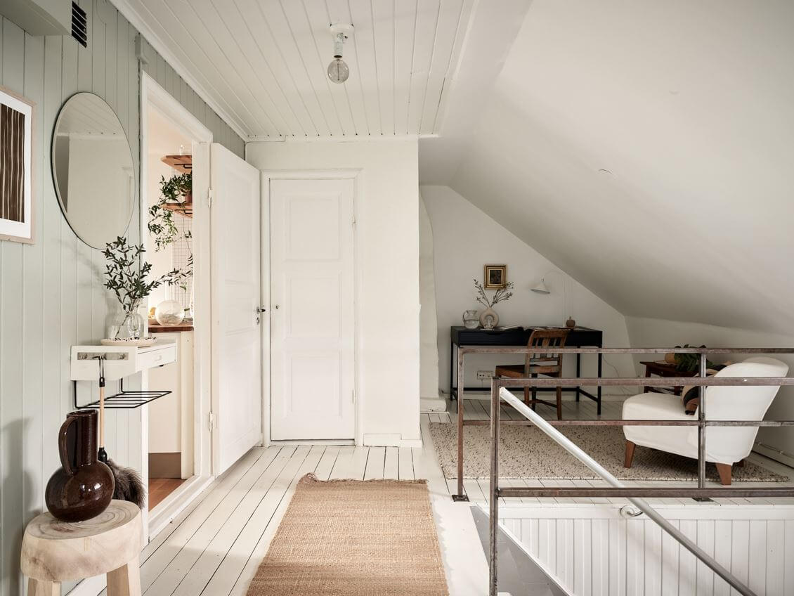 A White Scandinavian Attic Apartment 7 attic-apartment-home-office-slanted-ceiling-nordroom