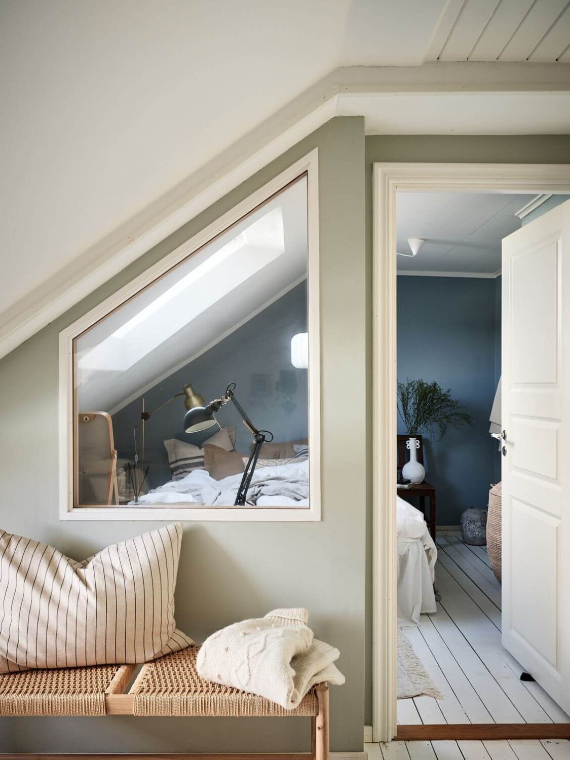 A White Scandinavian Attic Apartment 10 attic-apartment-indoor-window-bedroom-nordroom