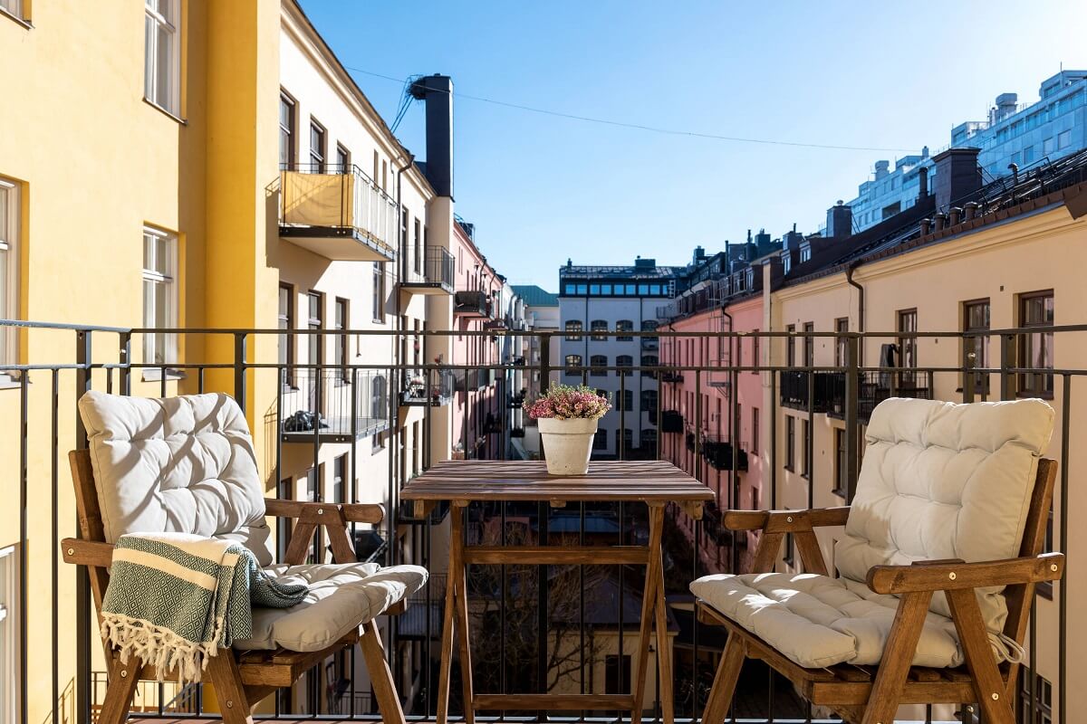 A Small Stockholm Apartment with Lovely Natural Light 14 balcony colorful scandinavian buildings stockholm nordroom