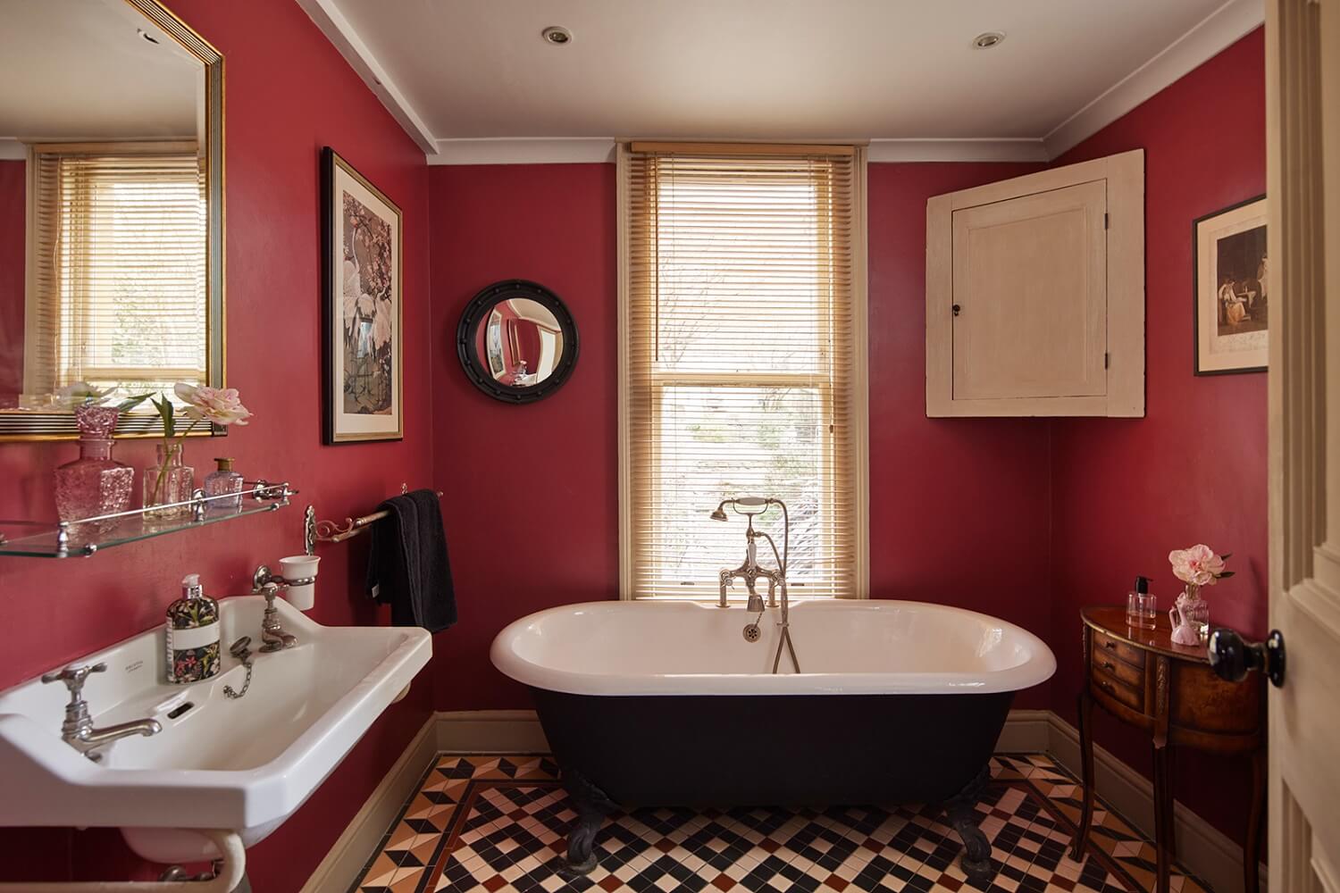 Colorful Rooms and Unique Decor in a Home in Bath 23 bathroom-pink-red-walls-intricate-mosaic-tiled-floor-freestanding-bath-nordroom