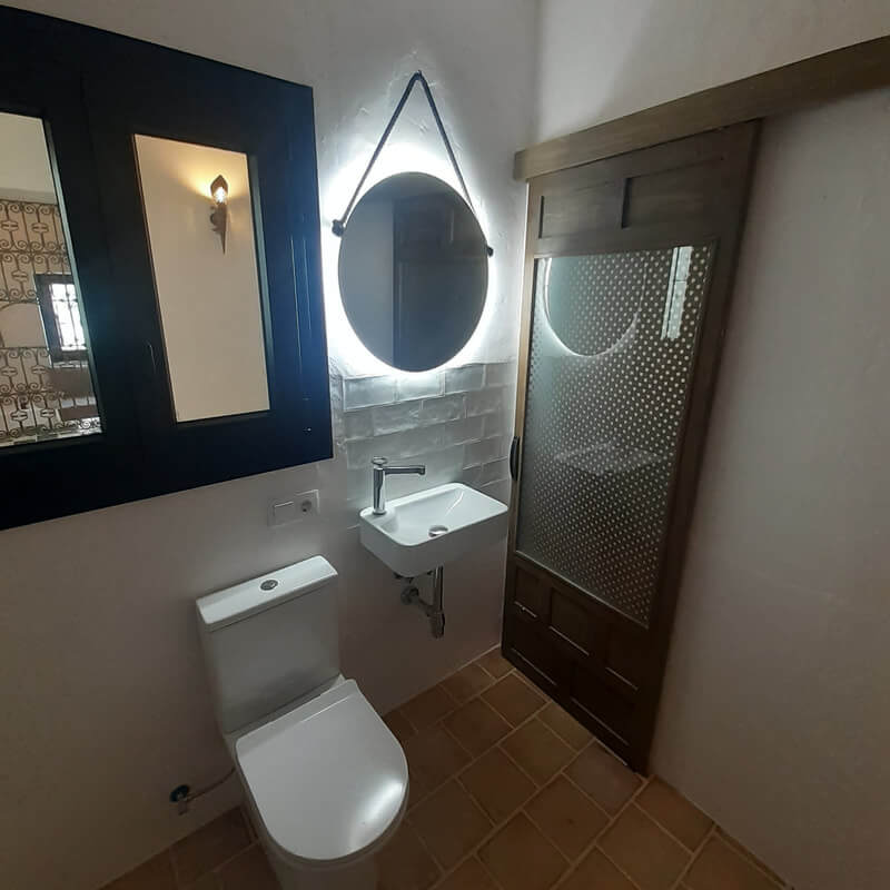 Casita Alborán: A Stylish Home in a Spanish Seaside Town 21 bathroom-stone-floor-lighted-mirror-nordroom