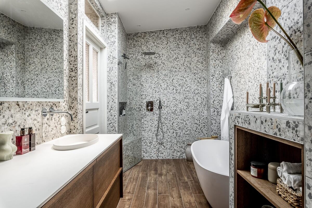 A Swedish Maisonette with a Blue Kitchen and Wallpaper 27 bathroom-terrazzo-tiles-wood-style-floor-tiles-freestanding-bath-nordroom