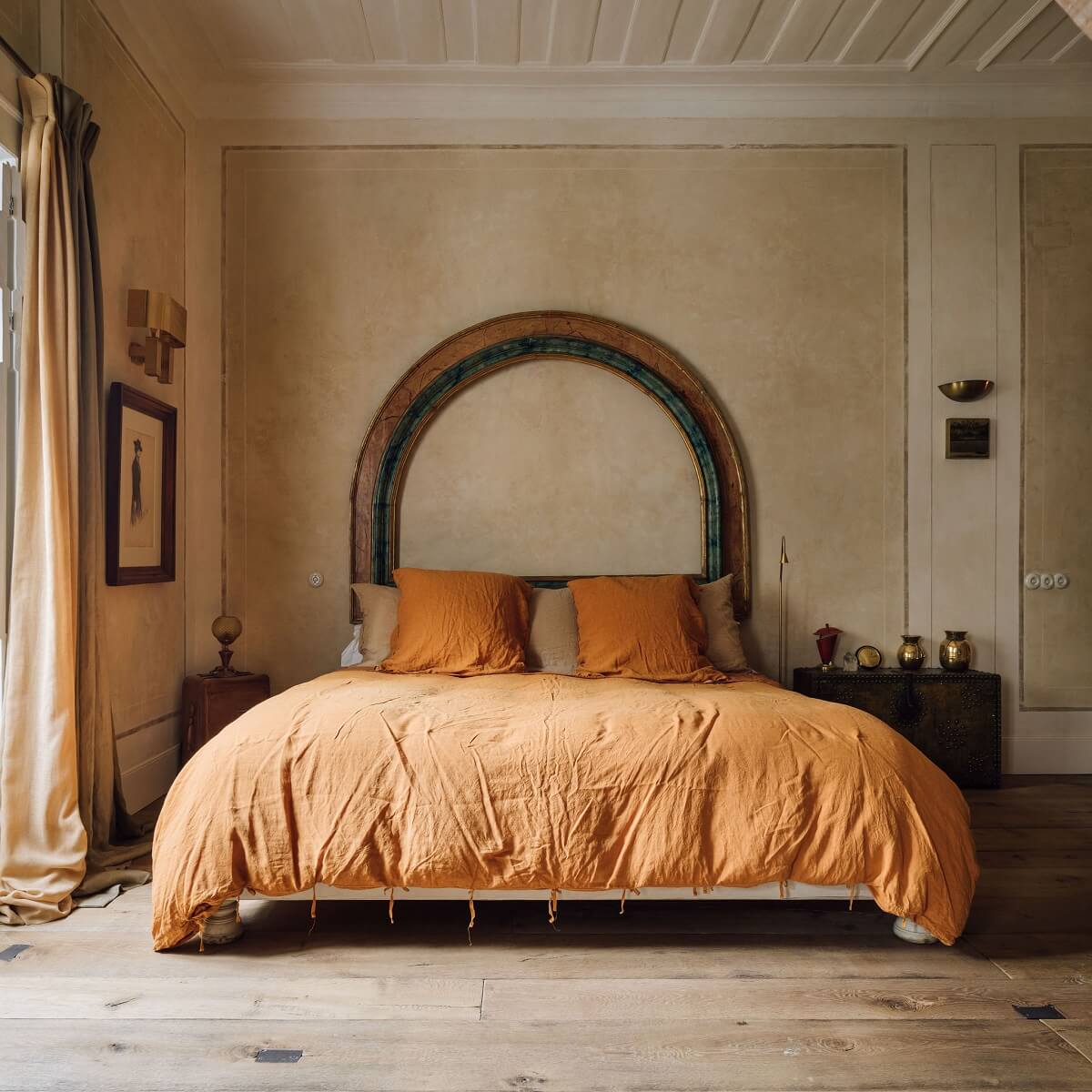 A Lisbon Townhouse with Historic Charm 9 bedroom-arched-accent-wall-ochre-yellow-bedding-nordroom