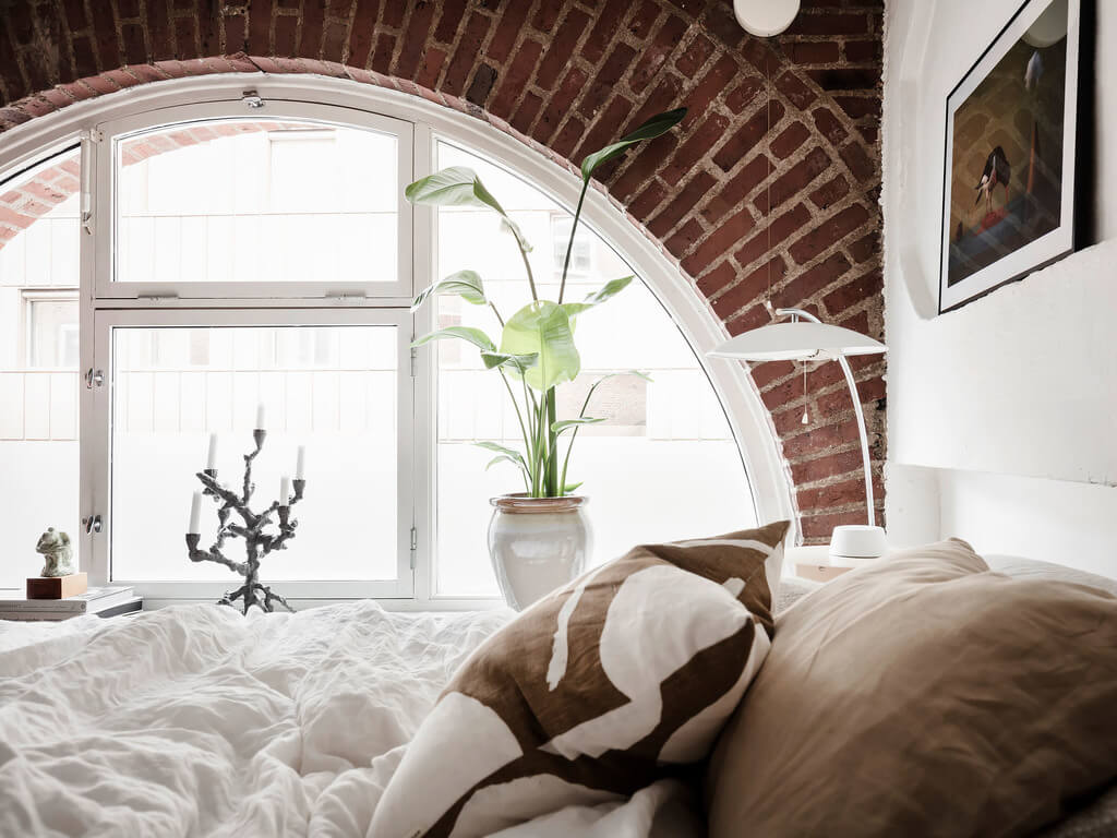 A Scandinavian Loft with Brick Wall and Arched Window 11 bedroom-brick-wall-nordroom